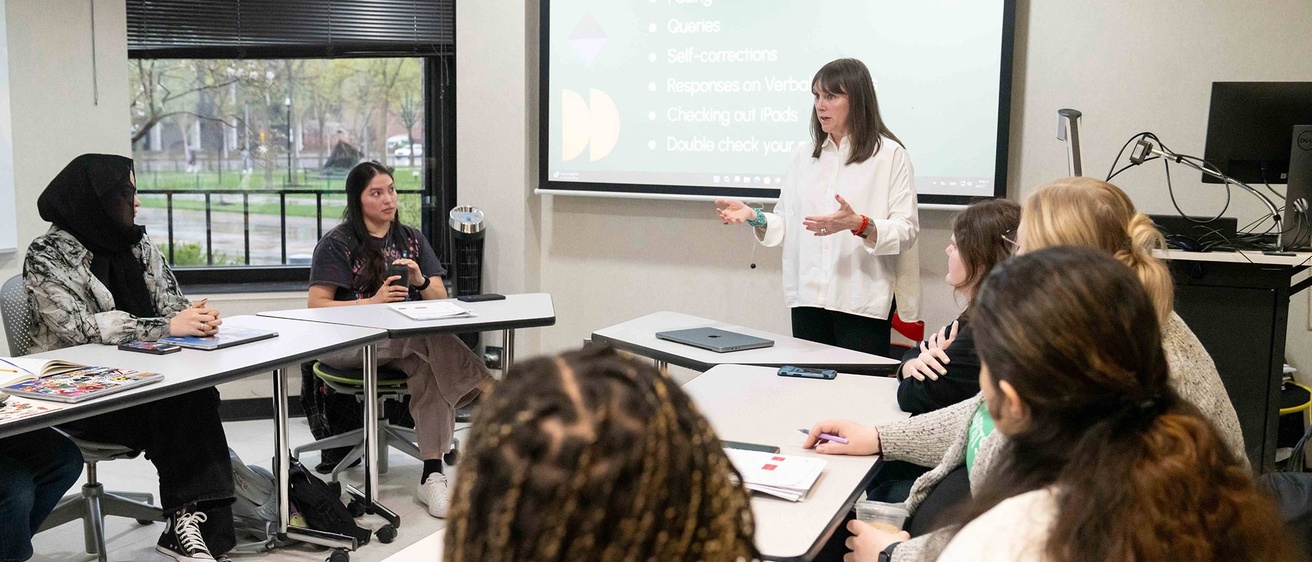 Associate Professor Amanda Case teaches in a small classroom 