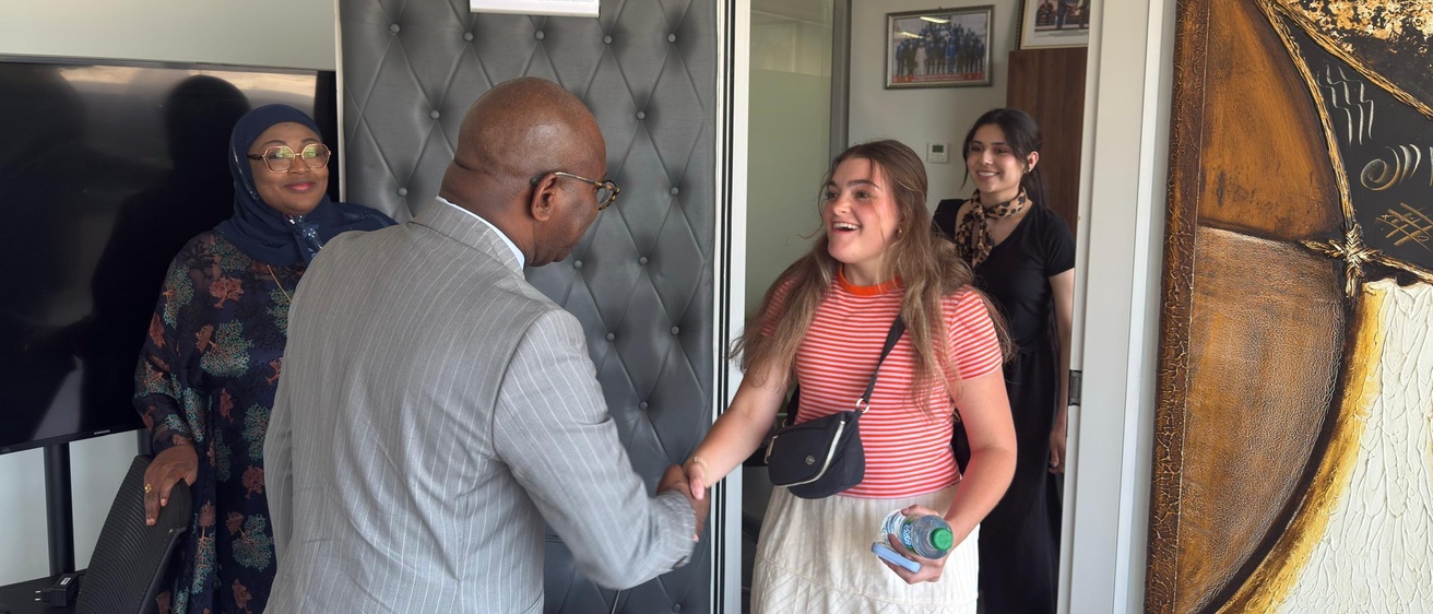 A smiling Caroline Keenan shakes hands with the Senegalese Minister of National Education