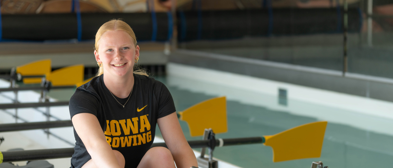 Young woman sits on rowing machine