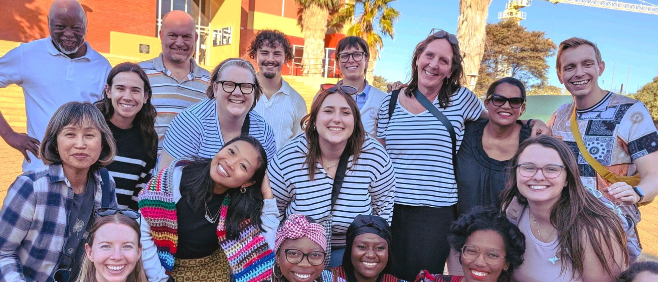 group of people poses towards camera