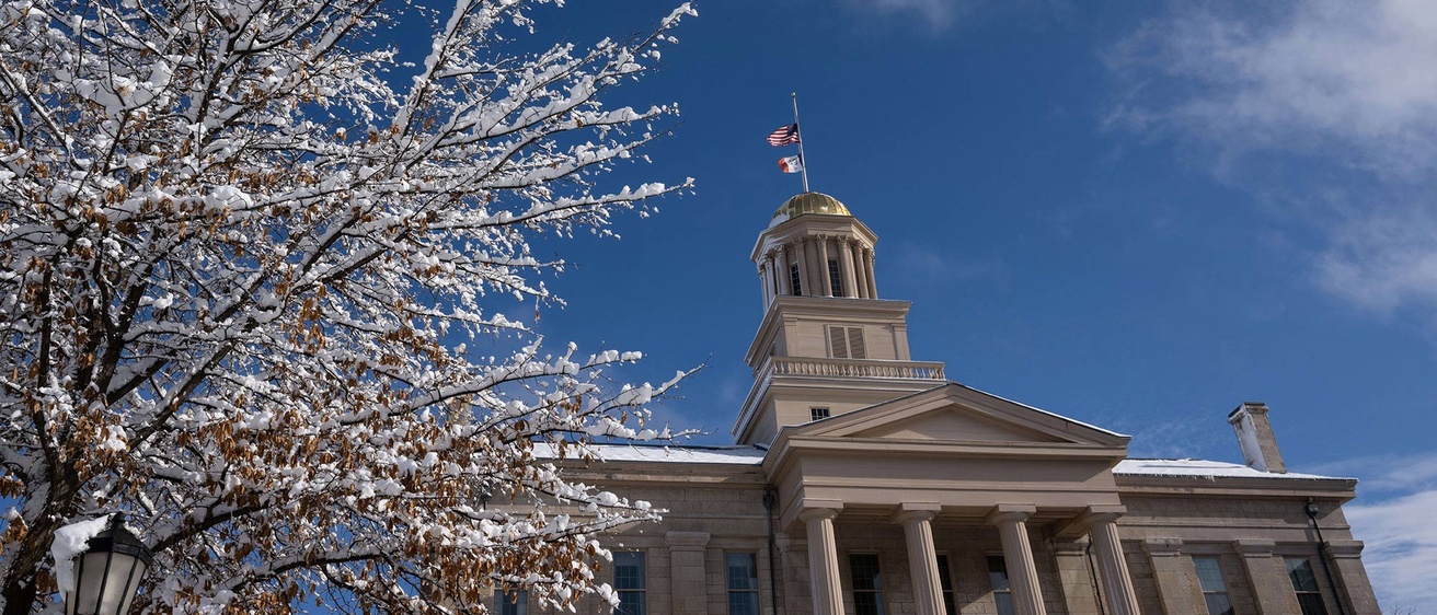 snowy landscape, blue sky, in front of Old Capitol 