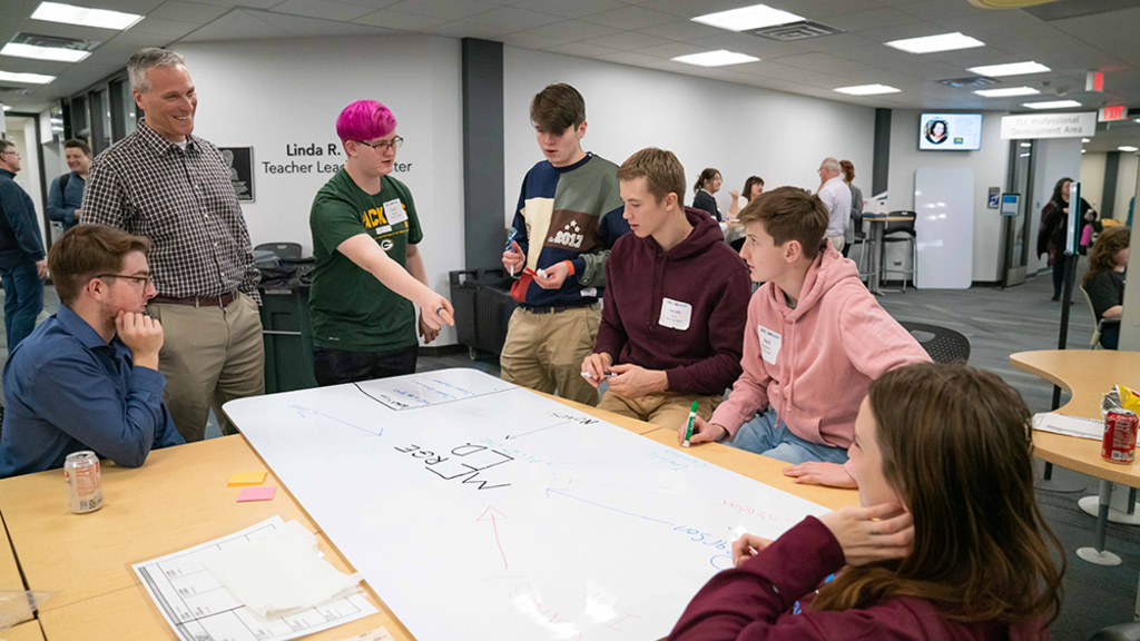 High school students and educators collaborate on a design plan