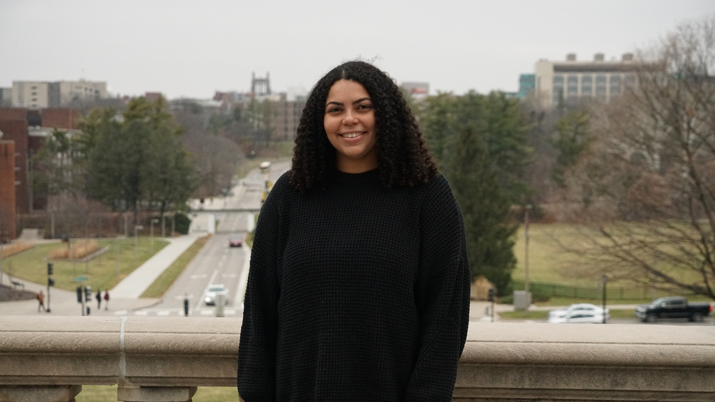 Graduating Senior Makayla Smith poses on the Old Capitol Building balcony on campus at the University of Iowa