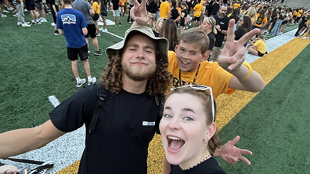 •	Joe Goltl stands with other UI REACH staff and students at Kinnick Stadium.