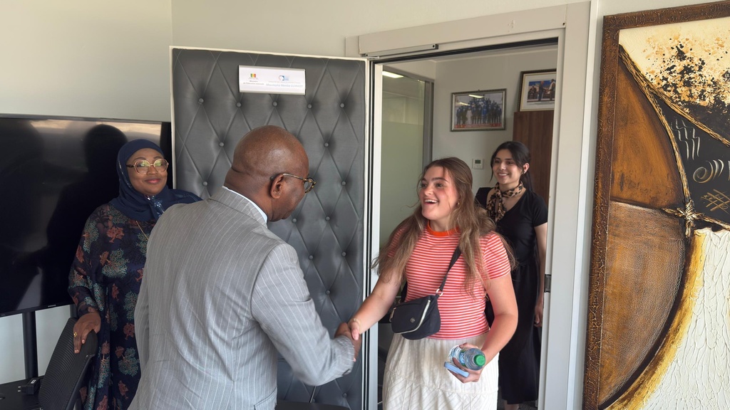 A smiling Caroline Keenan shakes hands with the Senegalese Minister of National Education