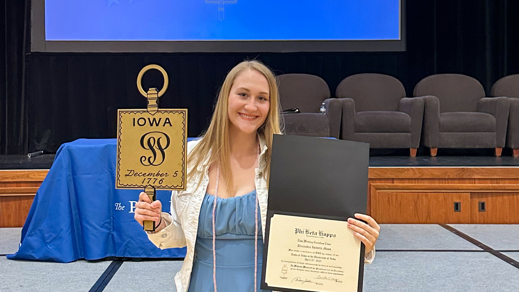 Lexi Moon shows her awards from the Phi Beta Kappa academic honor society