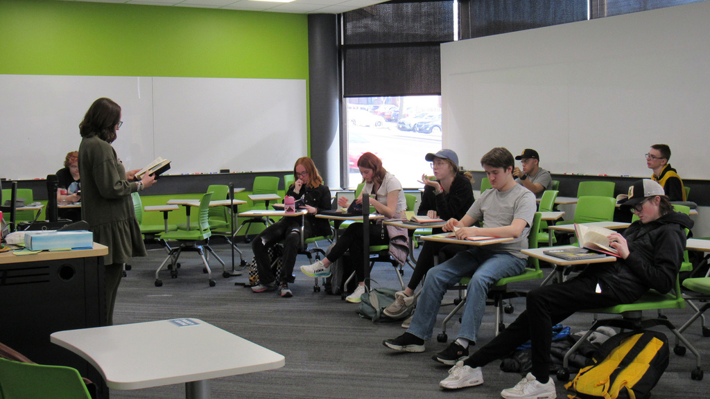 A teacher reads to class of students.